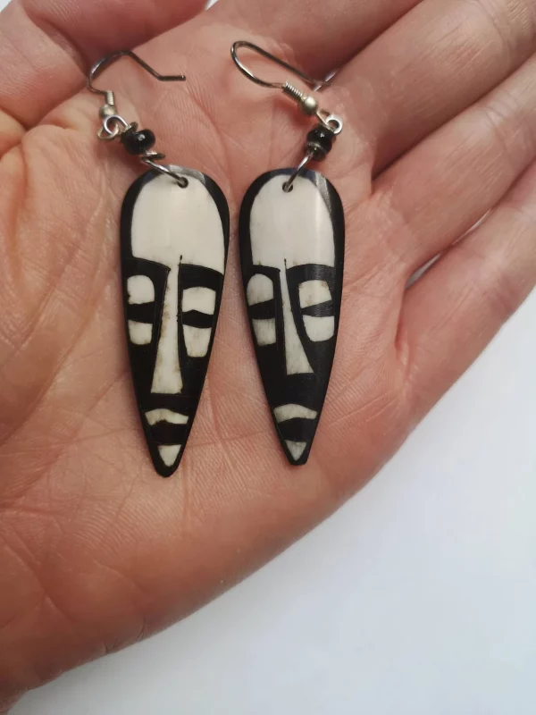 Handcrafted Vow bone earring in the shape of a African mask, black and white in colour