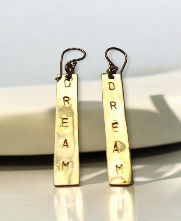 Handmade brass earrings with the word DREAM hand stamped on it